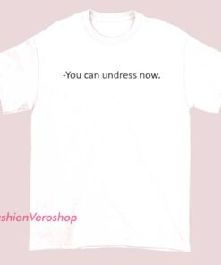 A unisex ringer T-shirt with contrasting collar and sleeve cuffs, featuring the playful text "You Can Undress Now" printed on the front. The shirt has a casual and humorous style, perfect for everyday wear.