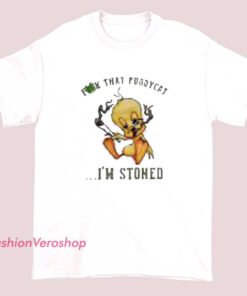 A humorous t-shirt design featuring the phrase "Tweety, fuck that puddycat, I'm stoned" in bold, playful lettering, with cartoon-style imagery of Tweety Bird and a relaxed cat, emphasizing a cheeky, laid-back vibe.
