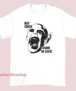 A limited edition vintage-style shirt featuring an illustration of a bat child discovered in a cave, with a mysterious and adventurous design.