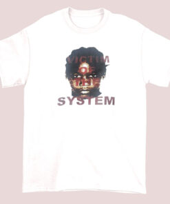 Unisex adult t-shirt featuring the text 'Victim of the System' with a design or graphic referencing Bruce Dropemoff, styled in a casual, streetwear-inspired look