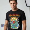 Psychedelic Sublime sun and koi artwork shirt featuring colorful fish imagery, retro psychedelic graphics, alternative music style, cotton short sleeve tee, and bold streetwear fashion